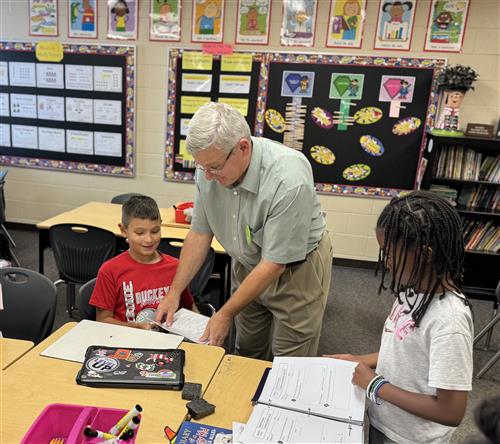 Male Teacher with male and female students